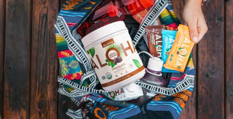 a person is holding a backpack filled with aloha products