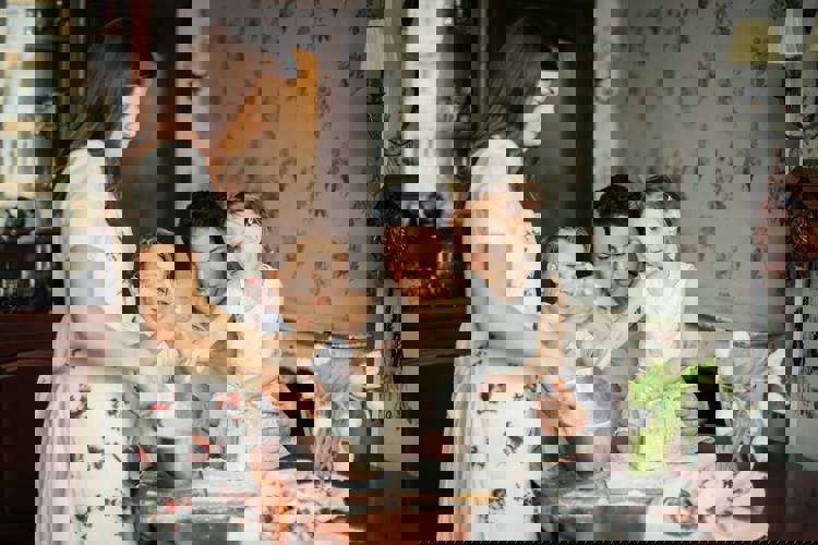 a family is preparing food together in the kitchen