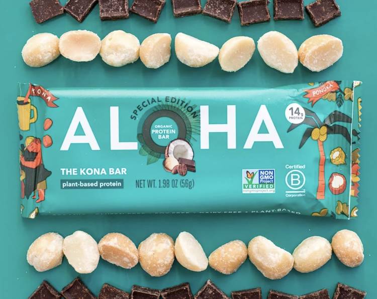 the kona bar is surrounded by macadamia nuts and chocolate